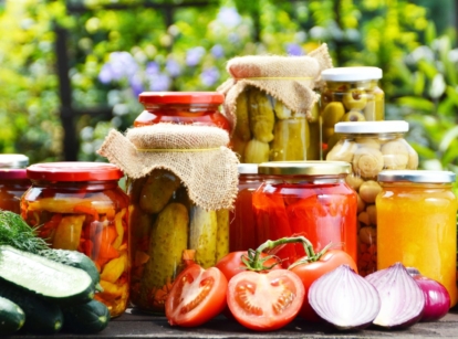 A close-up shot of a composition of various jarred crops, showcasing the best vegetables to preserve
