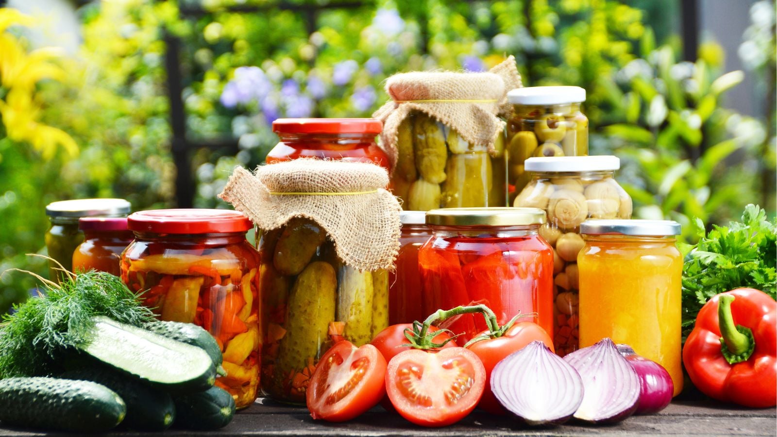 A close-up shot of a composition of various jarred crops, showcasing the best vegetables to preserve