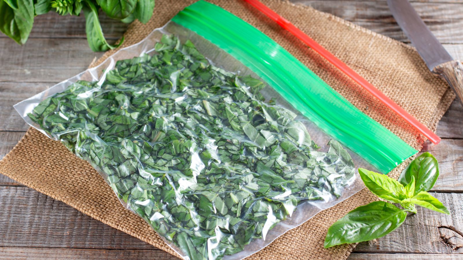 A shot of a plastic bag with frozen herbs on top of a woven mat in a well lit area