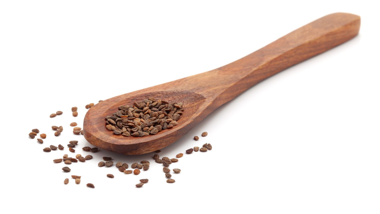 An isolated shot of a wooden spoon with seeds of a wildflower