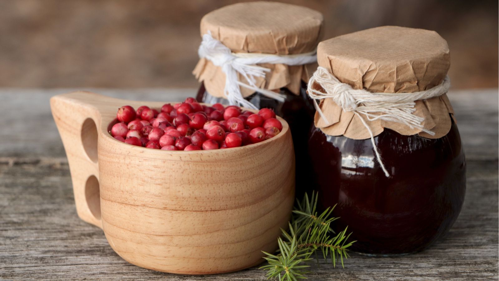 A shot of harvested fruits and jars with jam all placed in a well lit area