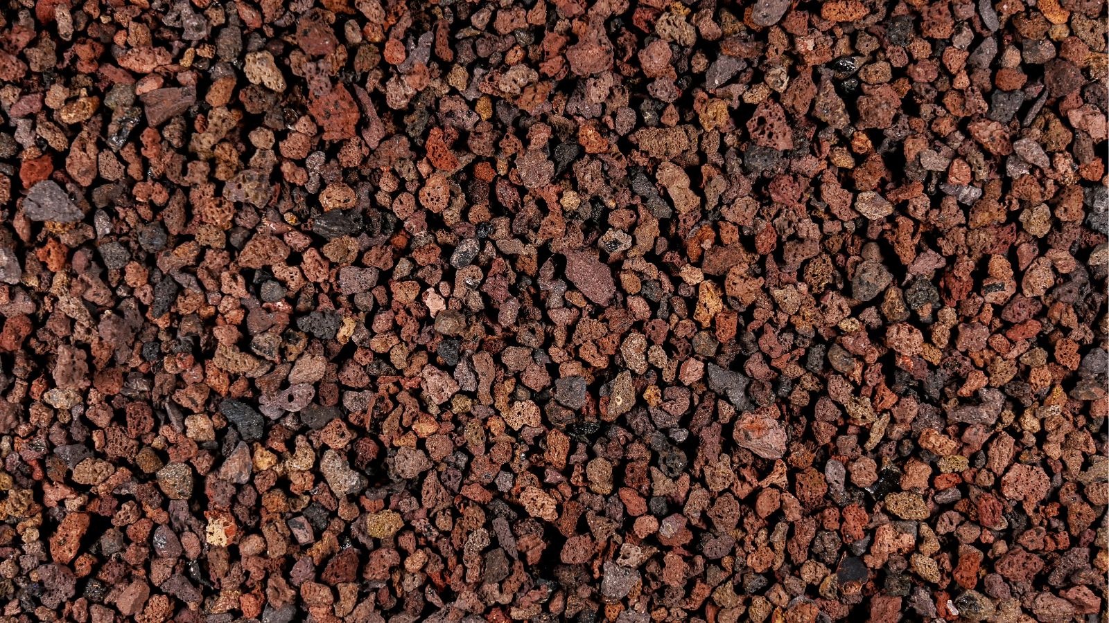 A close-up and overhead shot of a composition of small brown-red colored gravel material