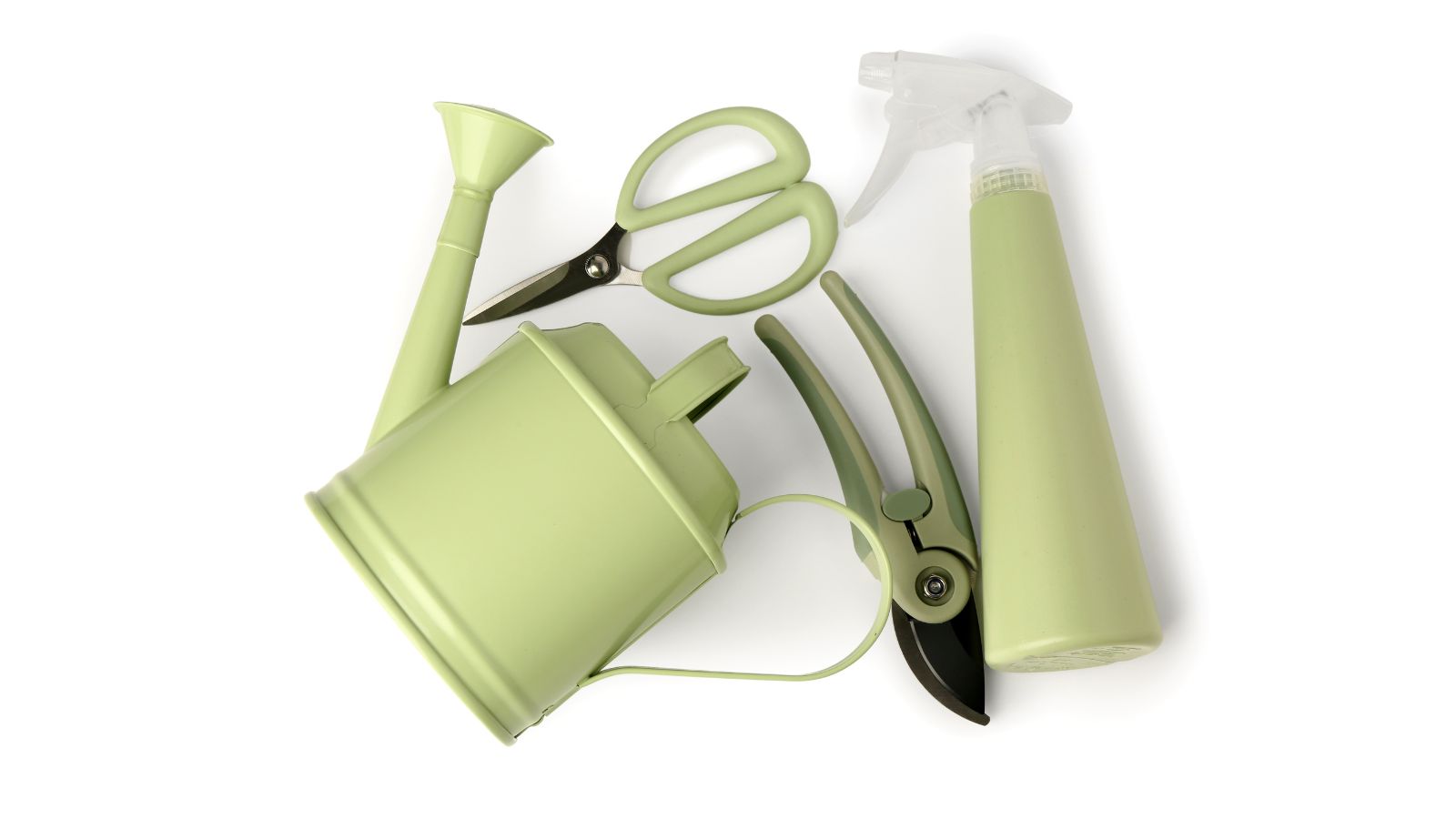 An overhead shot of several gardening tools including scissors, watering can, pruners, and a misting bottle.