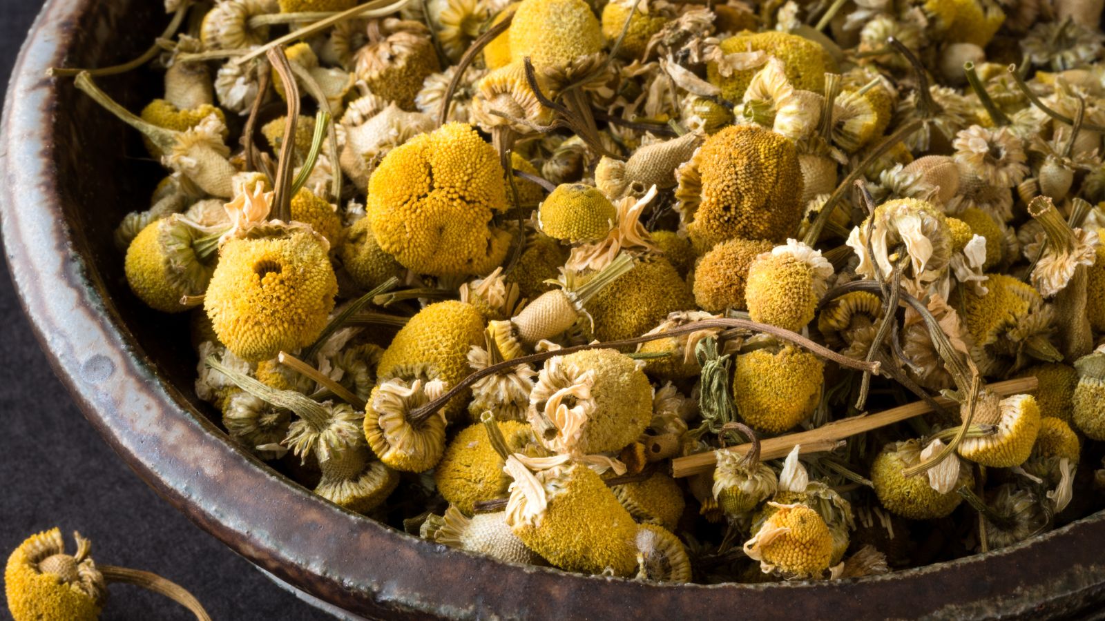 A close-up shot of dried flowers on a bowl in a well lit area