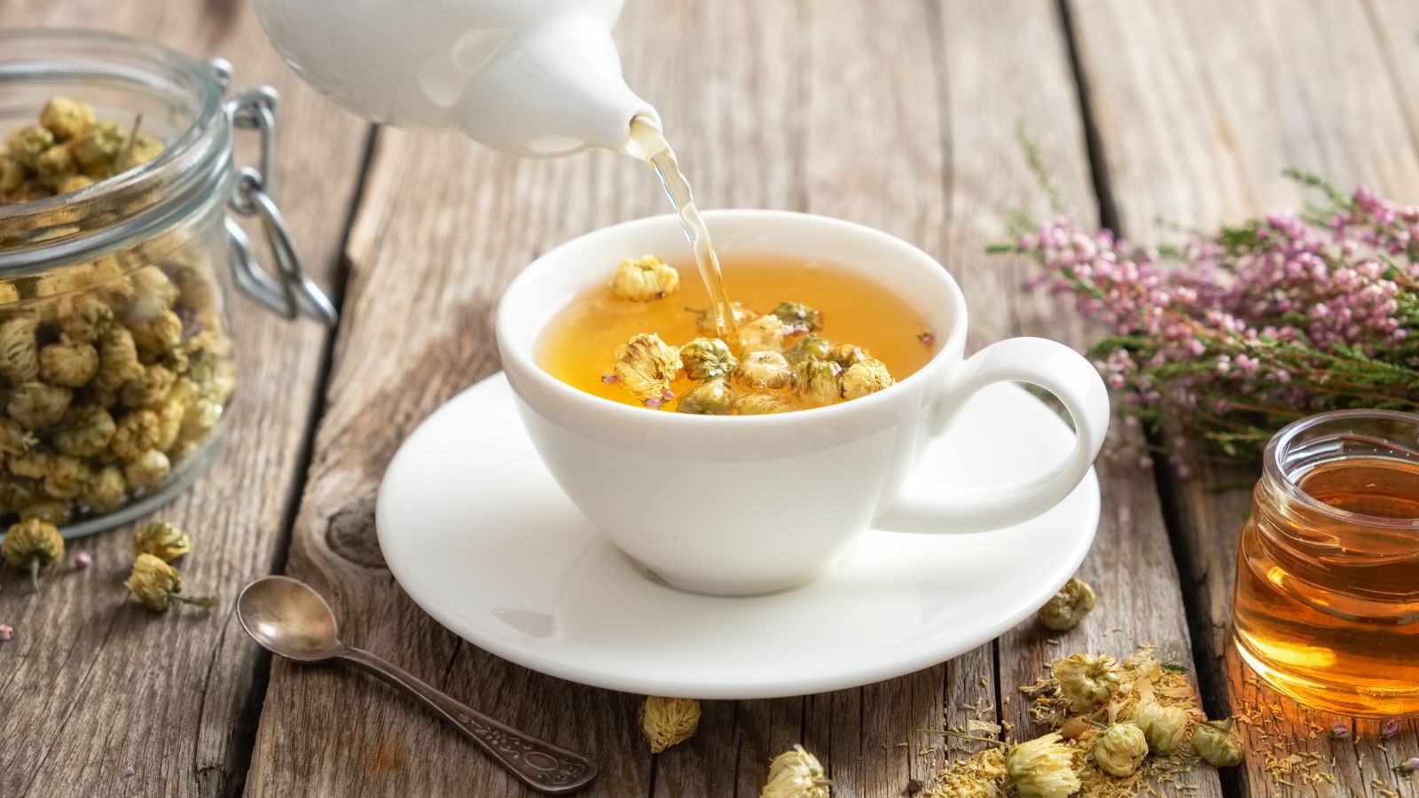 A shot of a tea making process using white flowers in a well lit area