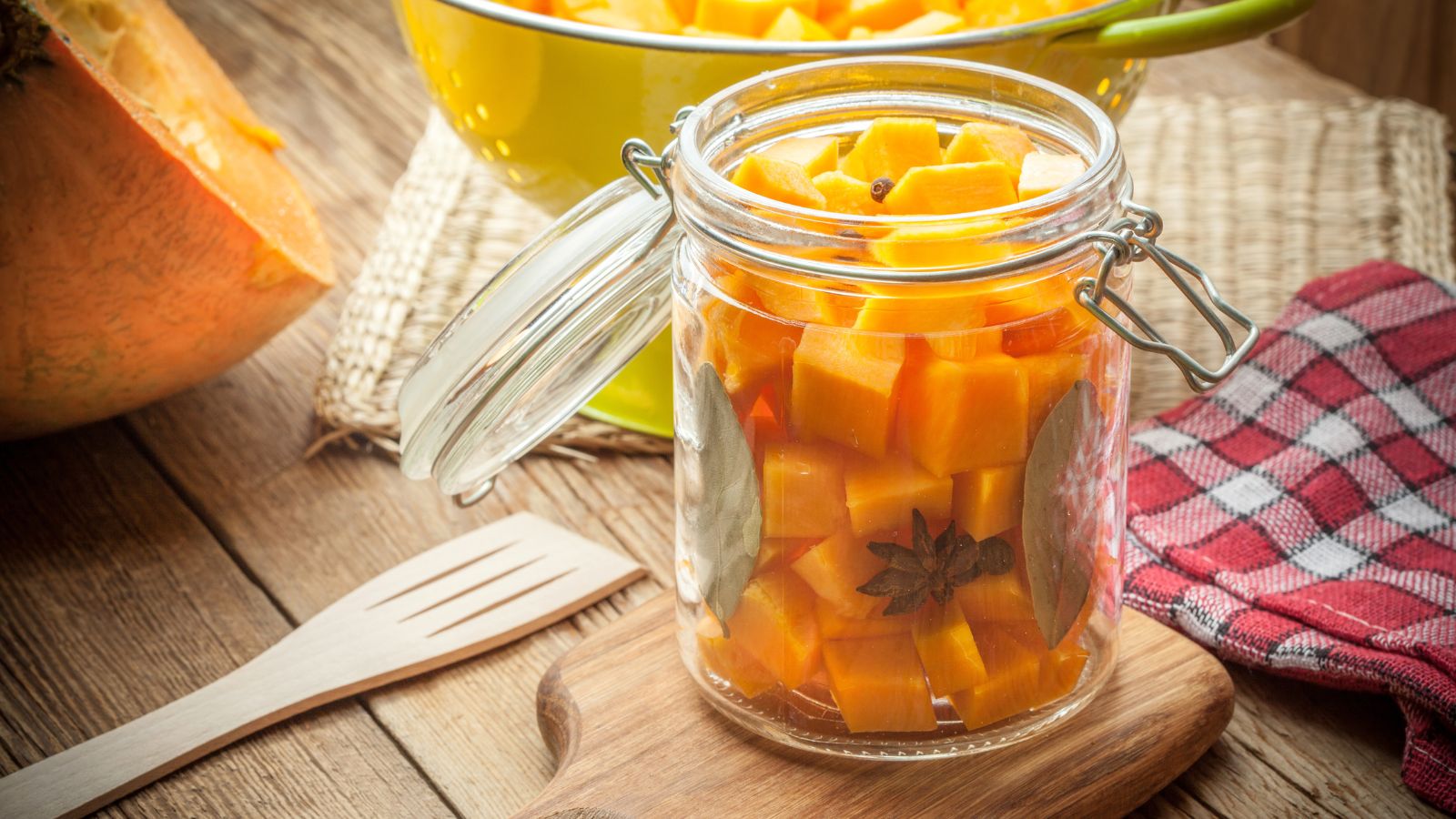 A shot of jar pickling orange crops in a well lit area indoors